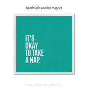 Teal square magnet with white text 'It's okay to take a nap' on a white background